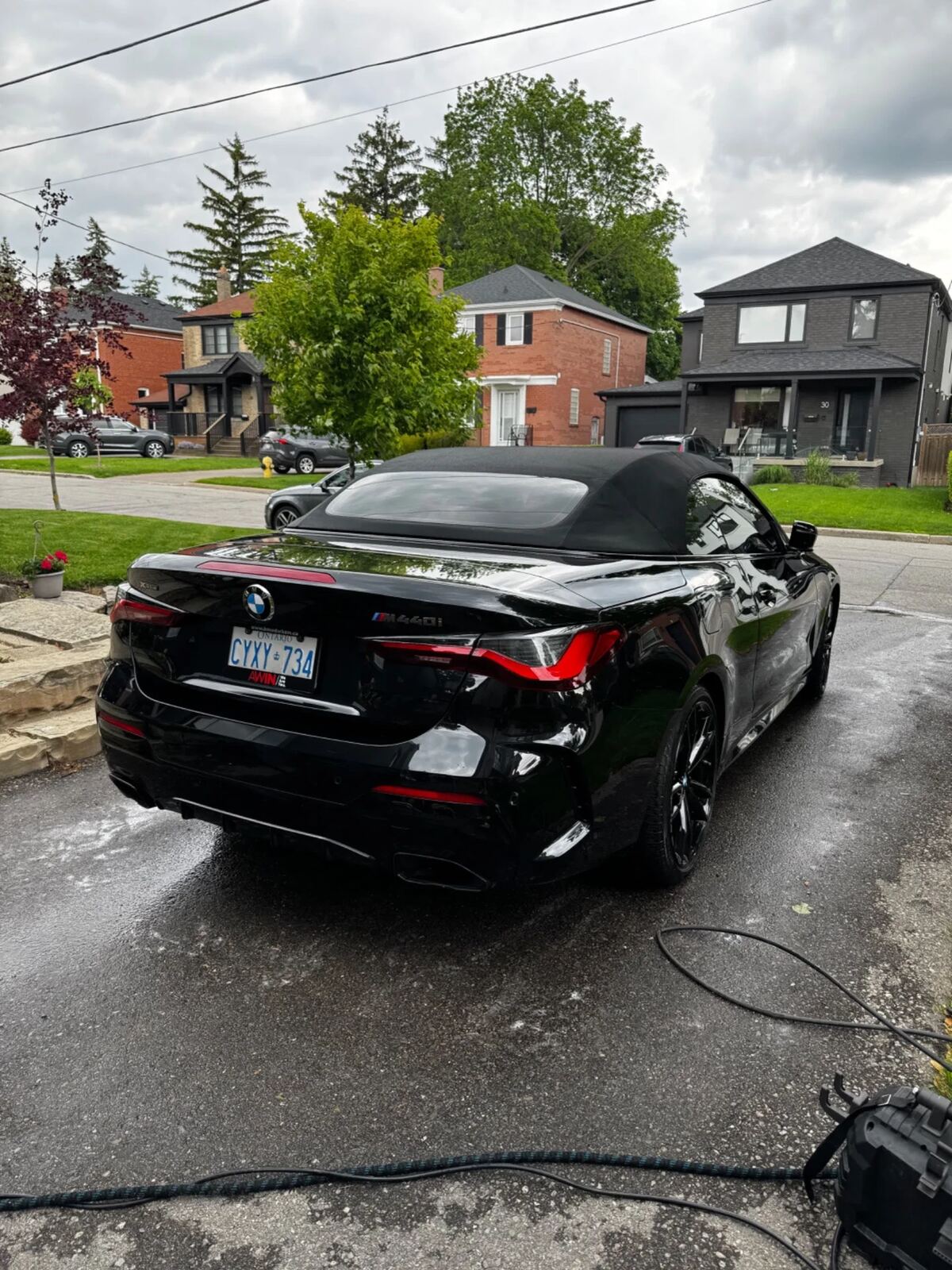 Rear quarter of a black BMW M440i showing deep gloss and clean wheels after a CJ detail