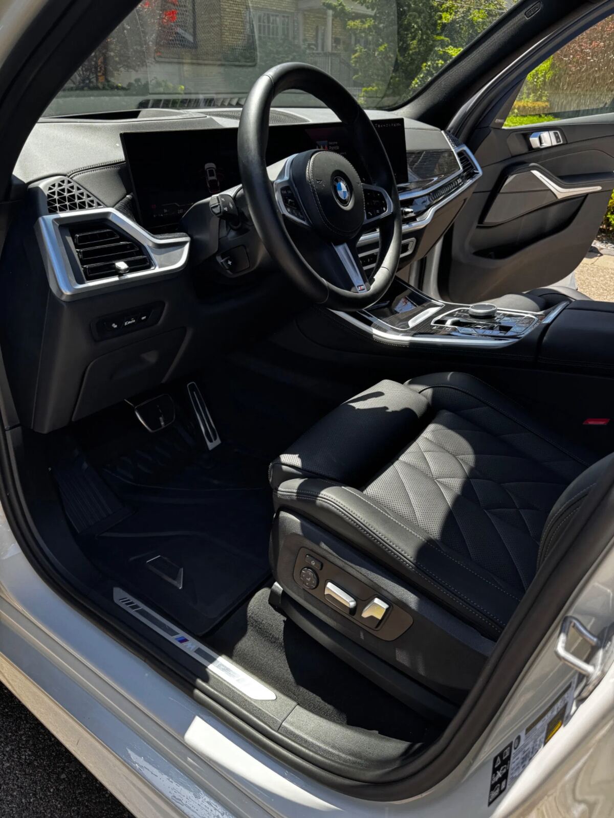 Detailed BMW X5 front cabin — glossy dashboard and cleaned leather seats