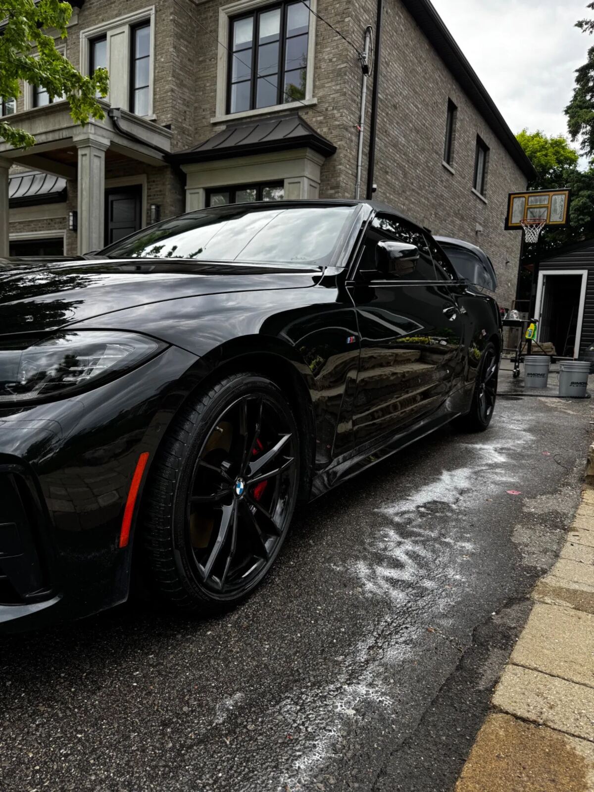Black BMW M-Series coupe after a full exterior detail with beading water and gloss paintwork