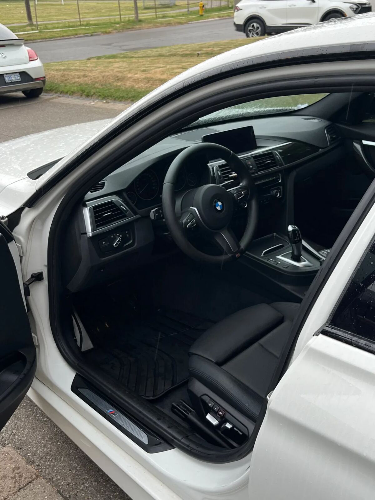 White BMW 3-Series front cabin after interior detail — clean dash and steering wheel
